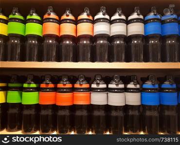 Close up sport water bottles on shelf in shopping mall