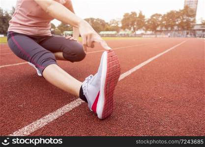Close up sporty woman is Stretch in sport field