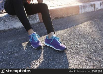 close up sporty woman with purple sneakers