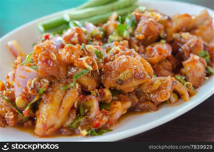 close up stir fried chicken with sweet sauce , chili and mix vegetable , served with fresh vegetable on dish