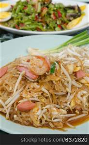 close up stir fried noodles with shrimp , egg, sausage and fresh vegetable
