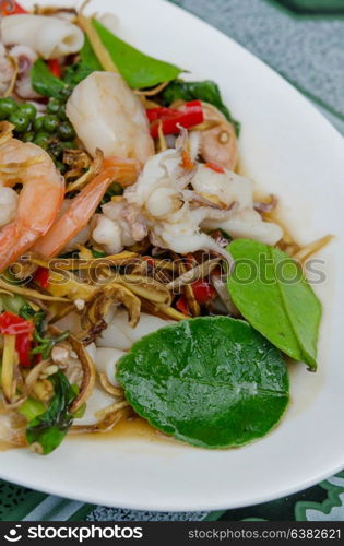 close up stir fried squid and shrimp with mix herbal on dish