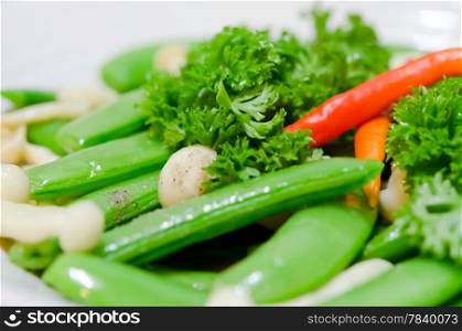 close up stir fried vegetables , pea , chili , parsley and mushroom