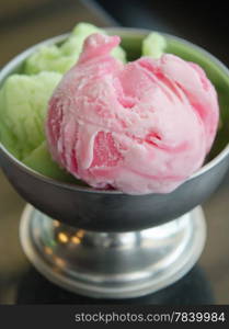 close up strawberry ice cream and green tea ice cream in bowl , delicious sweet dessert