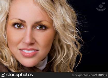 Close up studio portrait of a beautiful young blond model with blond hair and deep brown eyes.