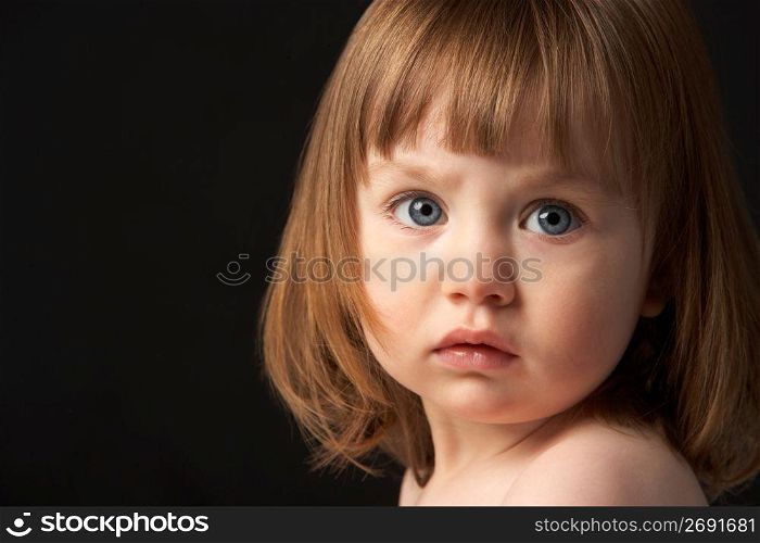 Close Up Studio Portrait Of Sad Young Girl
