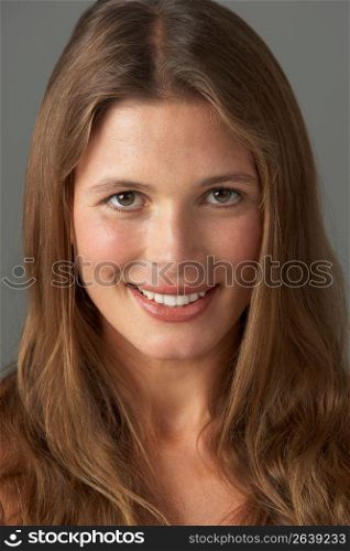 Close Up Studio Portrait Of Smiling Young Woman