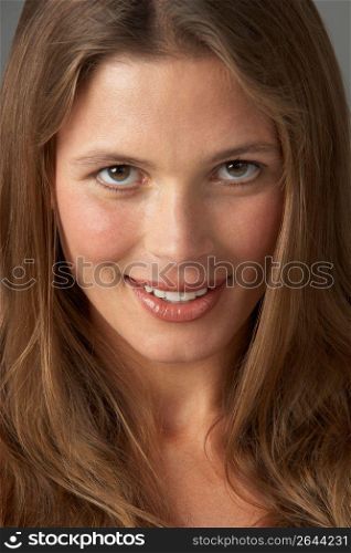Close Up Studio Portrait Of Smiling Young Woman
