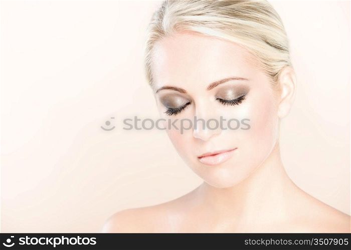 close-up studio portrait of young calm beautiful woman with eyes closed