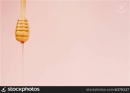 close up tasty honey pouring from stick