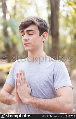 close up teen meditating outdoors