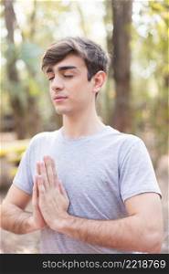 close up teen meditating outdoors