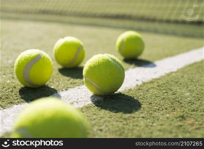 close up tennis balls ground