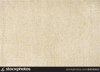 Close-up texture of natural beige coarse weave fabric or cloth. Fabric texture of natural cotton or linen textile material. Blue canvas background. Decorative fabric for upholstery, furniture, walls. Close up texture of beige coarse weave upholstery fabric. Decorative textile background