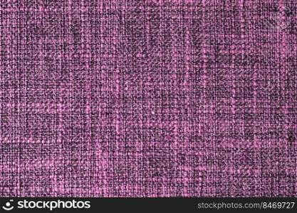Close-up texture of natural purple coarse weave fabric or cloth. Fabric texture of natural cotton or linen textile material. Blue canvas background. Decorative fabric for upholstery, furniture, walls. Close up texture of purple coarse weave upholstery fabric. Decorative textile background