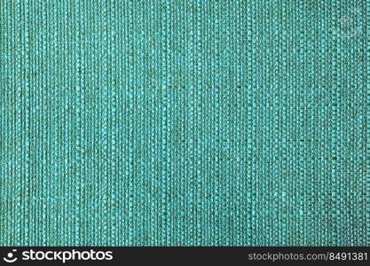 Close-up texture of natural turquoise coarse weave fabric or cloth. Fabric texture of natural cotton or linen textile material. Blue canvas background. Decorative fabric for upholstery, furniture, walls. Close up texture of turquoise coarse weave upholstery fabric. Decorative textile background