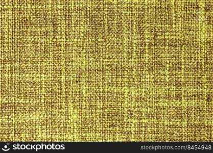 Close-up texture of natural yellow coarse weave fabric or cloth. Fabric texture of natural cotton or linen textile material. Blue canvas background. Decorative fabric for upholstery, furniture, walls. Close up texture of yellow coarse weave upholstery fabric. Decorative textile background