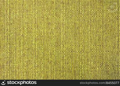 Close-up texture of natural yellow coarse weave fabric or cloth. Fabric texture of natural cotton or linen textile material. Blue canvas background. Decorative fabric for upholstery, furniture, walls. Close up texture of yellow coarse weave upholstery fabric. Decorative textile background