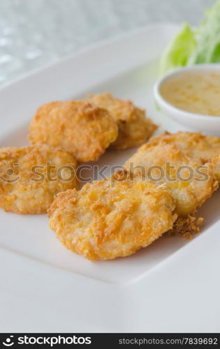 close up Thai Food Fried Fish Cake (Tod Mun Pla) with sweet sauce. fish cakes