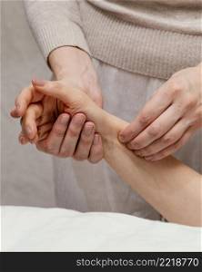 close up therapist massaging arm