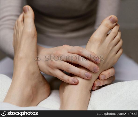 close up therapist massaging foot