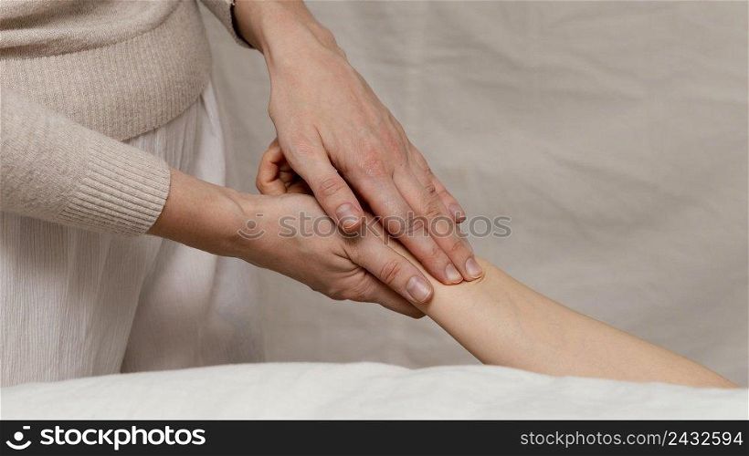 close up therapist massaging hand