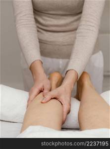 close up therapist massaging leg