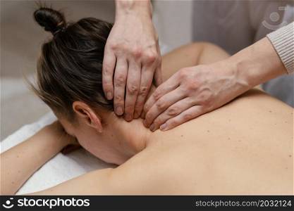 close up therapist massaging neck