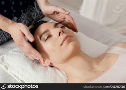 close up therapist massaging patient s ears