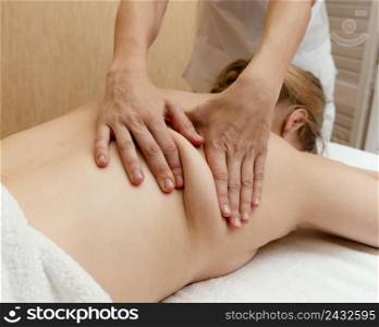 close up therapist massaging woman s back