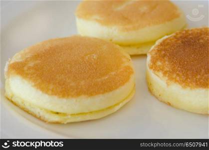 close up three pancake on white plate