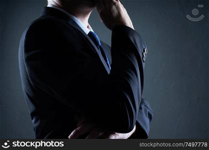 Close Up three quarter front view of businessman with thinking pose .