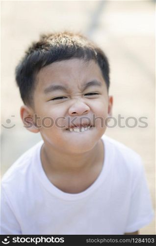 close up tooth and kidding face of asian children standing outdoor