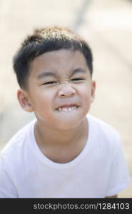 close up tooth and kidding face of asian children standing outdoor