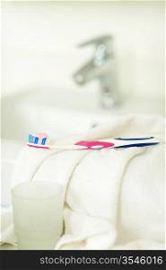 Close-up toothbrush with toothpaste on bathroom towel