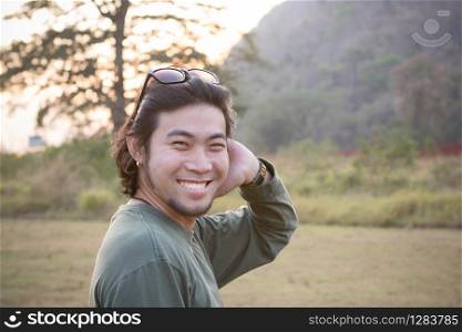 close up toothy smiling of asian man face relaxing vacation