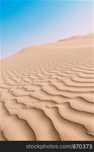 Close up top view of sand dune surface with undulated wave patterns former by wind.. Close up top view of sand dune surface with undulated wave patterns former by wind