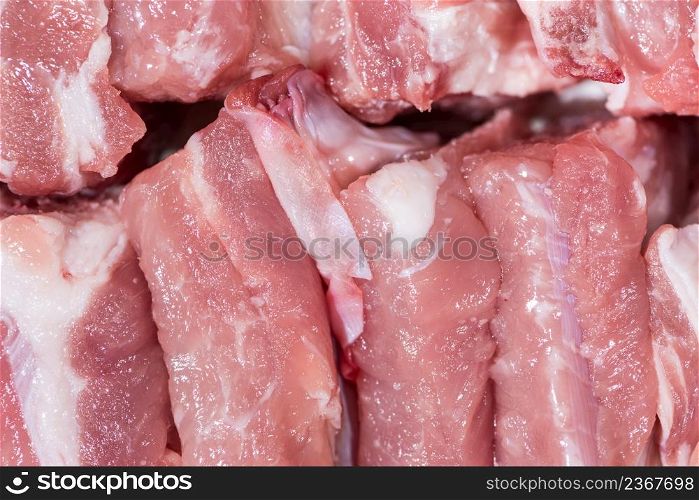 Close up top view pack pieces raw meat of pork loin on bone, fresh red pork with white fat of pork rib, Cut into pieces and put them in a row. Close up pack raw pork rib