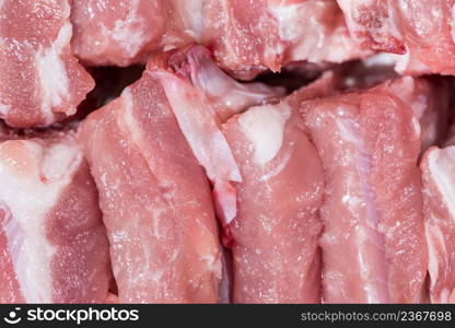 Close up top view pack pieces raw meat of pork loin on bone, fresh red pork with white fat of pork rib, Cut into pieces and put them in a row. Close up pack raw pork rib