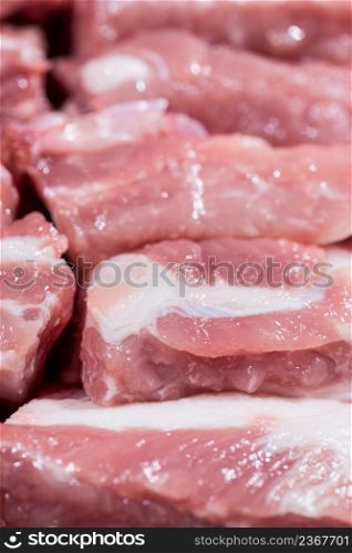 Close up top view pack pieces raw meat of pork loin on bone, fresh red pork with white fat of pork rib, Cut into pieces and put them in a row. Close up pack raw pork rib