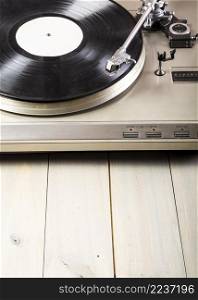 close up turntable vinyl record player wooden table