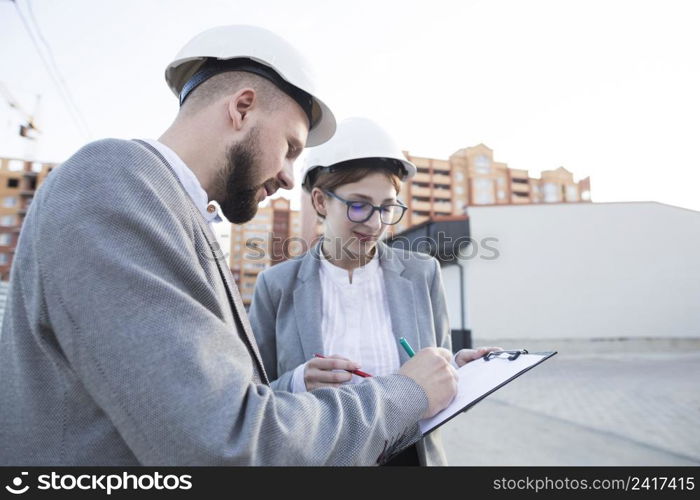 close up two architect working together construction site