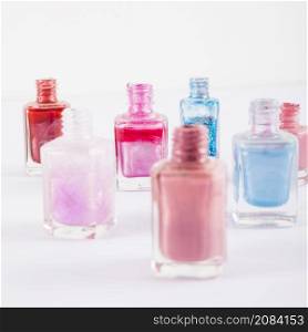 close up various multi colored nail polish bottles