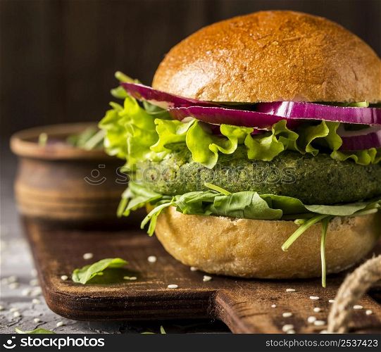 close up vegetarian burger cutting board