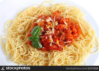 Close-up vertical view of Spaghetti al Pomodoro - spaghetti with tomato and vegetable sauce, topped with grated parmesan - a traditional Italian dish.