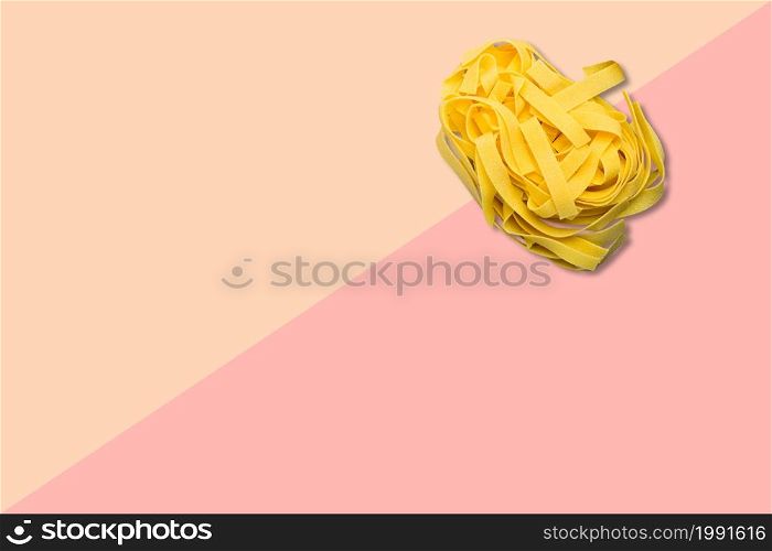 Close up view italian raw spaghetti isolated on pink background.