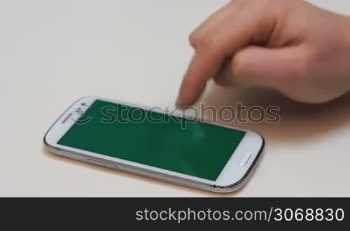 Close up view of a businessman using multi gestures on a smartphone to zoom in a document