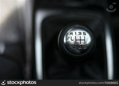 Close up view of a gear lever shift. Manual gearbox. Car interior details. Car transmission. Soft lighting. Abstract view. European car