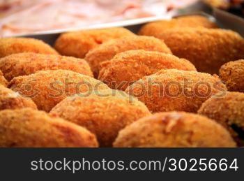 close-up view of a group of fried rice balls (Sicilian arancini)