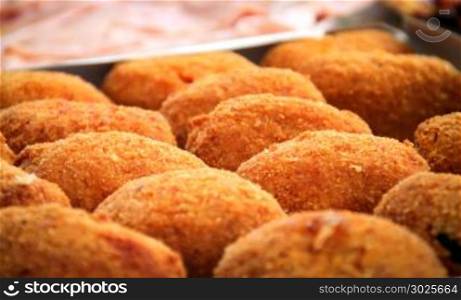 close-up view of a group of fried rice balls (Sicilian arancini)